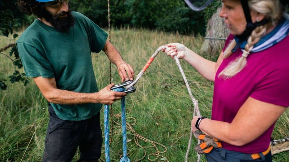 Use of pulleys and  tackle rings can help in securing rope between two trees