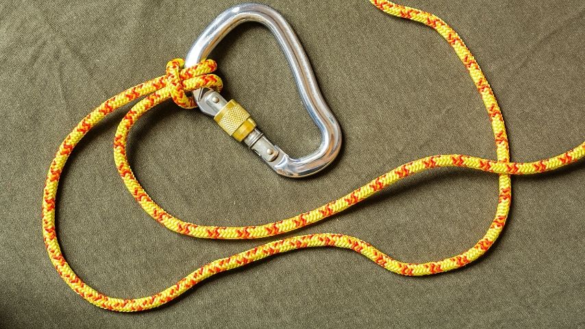 The second step to creating a prusik knot is to coil the rope around the main climbing line, forming a girth hitch