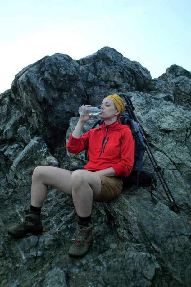 female hiker drinking water