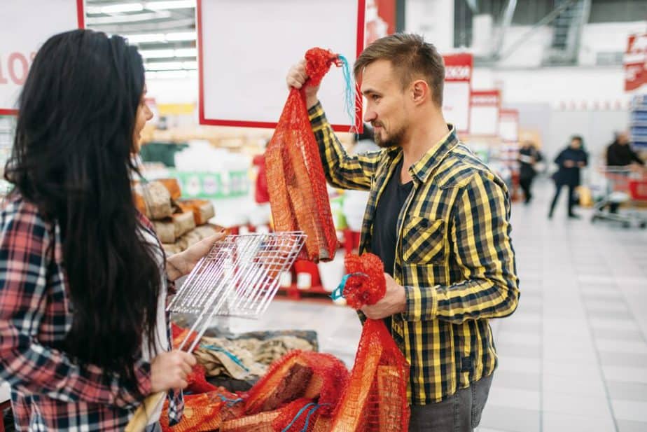 Young couple buying firewood in supermarket