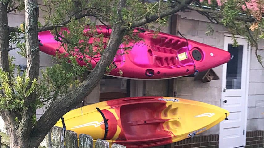 Kayaks mounted on wall hooks help save floor space in your garage