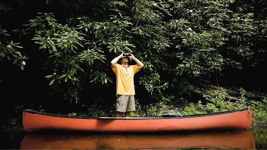 Leaning or standing on a canoe makes your gravity go off-center, causing your canoe to tip over