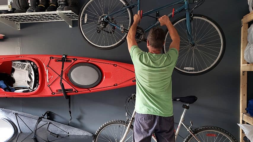 Wall-mounted racks for storing kayaks in your garage come with foam-padded racks to protect them from external damage